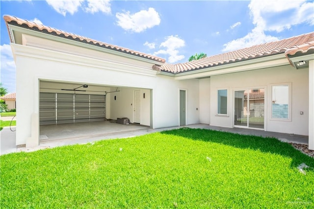 2607 Cottonwood St, Mission, TX 78574 - rear view of house featuring a tiled roof, a yard, stucco siding, and a garage