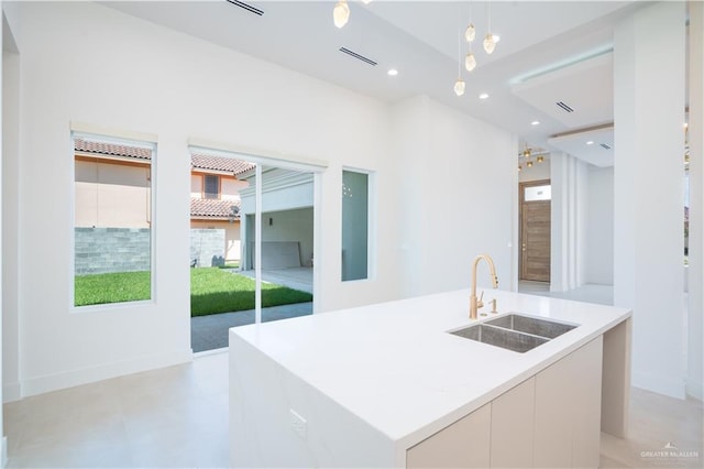2607 Cottonwood St, Mission, TX 78574 - kitchen featuring a sink, modern cabinets, a kitchen island with sink, hanging light fixtures, and light countertops
