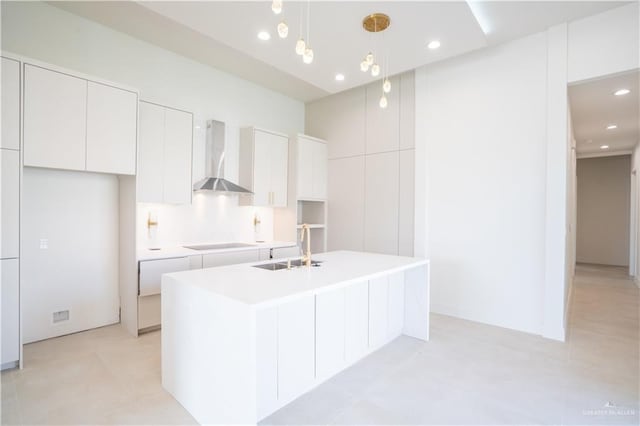 2607 Cottonwood St, Mission, TX 78574 - kitchen featuring wall chimney range hood, a sink, an island with sink, white cabinets, and recessed lighting