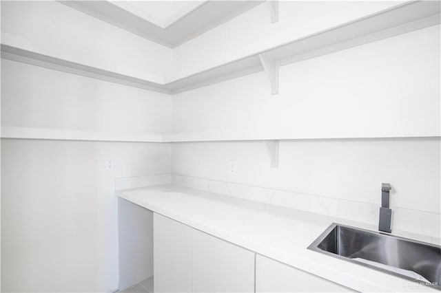 2607 Cottonwood St, Mission, TX 78574 - detailed view of light countertops, a sink, and white cabinetry