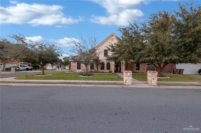 view of front of property with a front lawn and brick siding