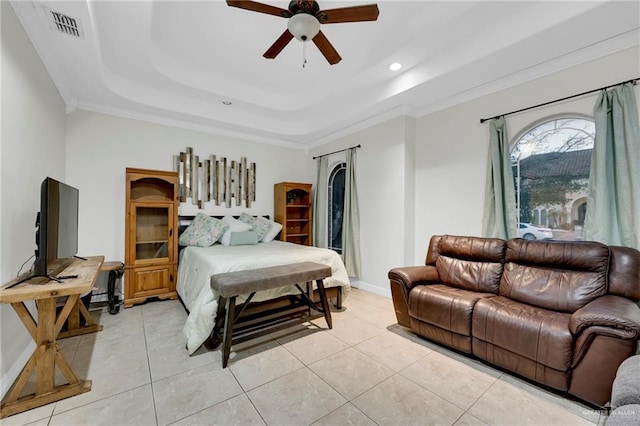 bedroom featuring light tile patterned flooring, visible vents, baseboards, a raised ceiling, and crown molding