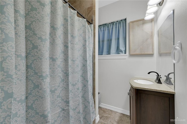 full bathroom featuring vanity and baseboards