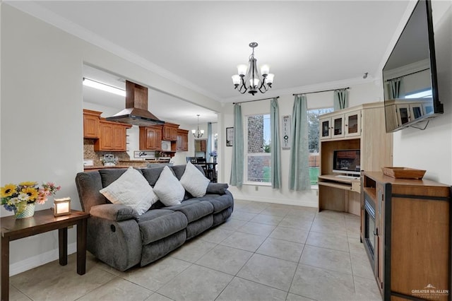 living room featuring crown molding, light tile patterned floors, baseboards, and a notable chandelier