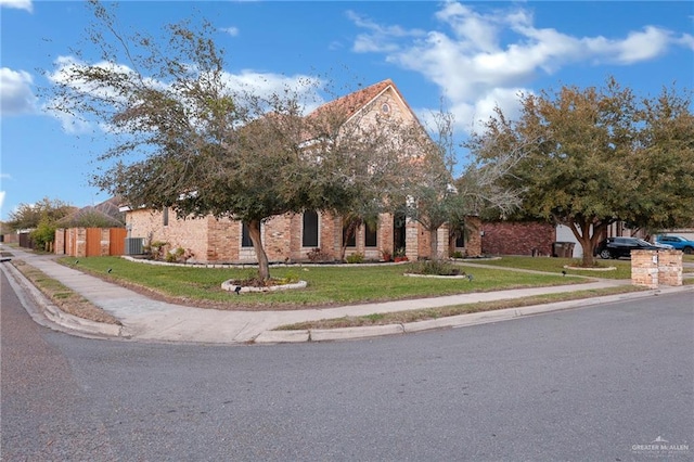 obstructed view of property with a front lawn and brick siding