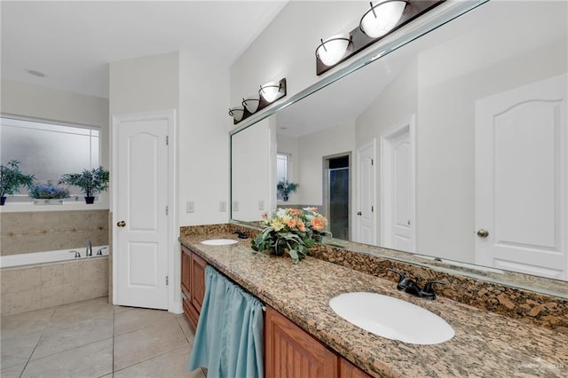 full bath featuring double vanity, a garden tub, a sink, and tile patterned floors