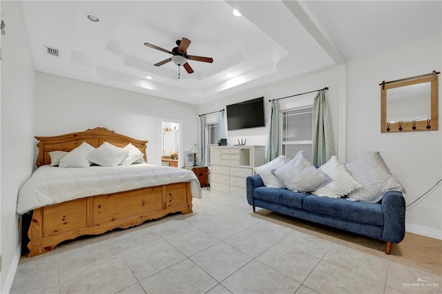 bedroom with baseboards, visible vents, a ceiling fan, a tray ceiling, and light tile patterned flooring