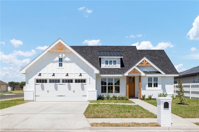 modern inspired farmhouse with a garage and a front yard