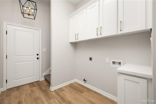 laundry room featuring cabinets, light wood-type flooring, hookup for a washing machine, a notable chandelier, and hookup for an electric dryer