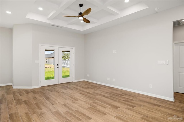 unfurnished room featuring french doors, beamed ceiling, coffered ceiling, and light wood-type flooring