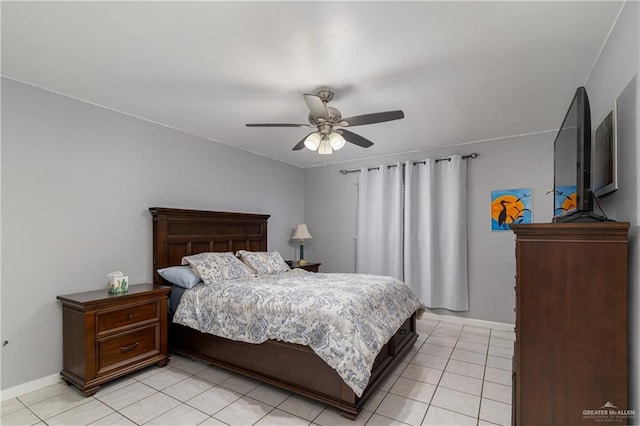 bedroom with light tile patterned flooring, baseboards, and a ceiling fan