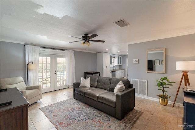 living room with light tile patterned floors, visible vents, french doors, and baseboards