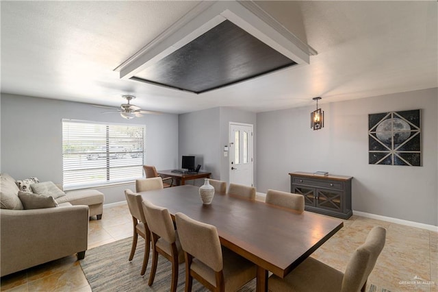 dining room featuring baseboards, light tile patterned flooring, and a ceiling fan