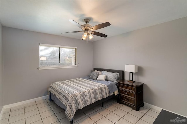 bedroom with light tile patterned floors, ceiling fan, and baseboards