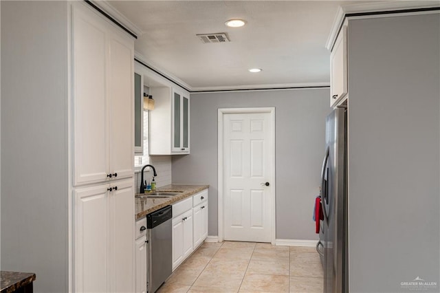 kitchen with visible vents, a sink, white cabinetry, stainless steel appliances, and light stone countertops