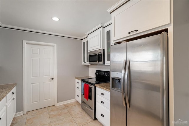 kitchen with tasteful backsplash, stone counters, white cabinets, and appliances with stainless steel finishes