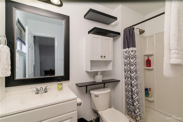 full bath featuring toilet, a stall shower, and vanity