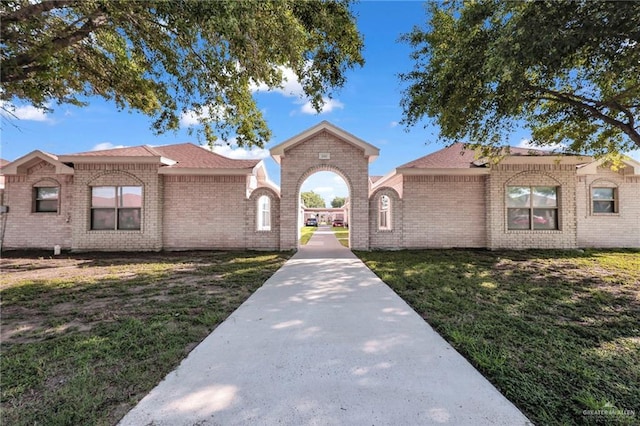 1010 Cedarwood Dr, Rio Grande City, TX 78582 - view of front of house featuring a front lawn and brick siding