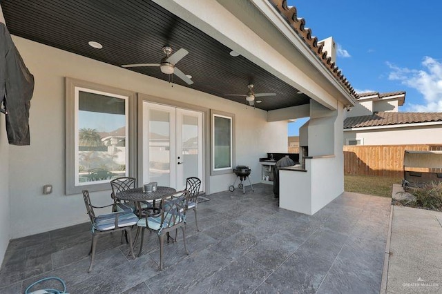 view of patio with area for grilling, ceiling fan, and french doors