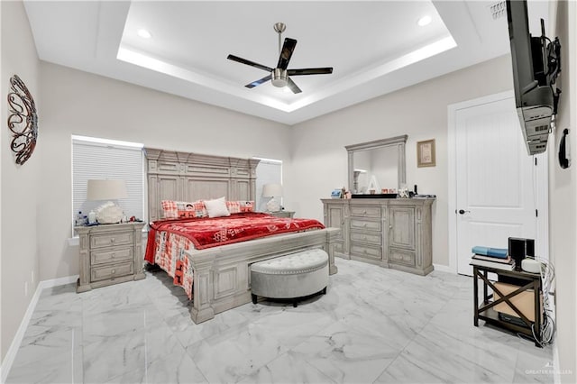 bedroom with ceiling fan and a raised ceiling