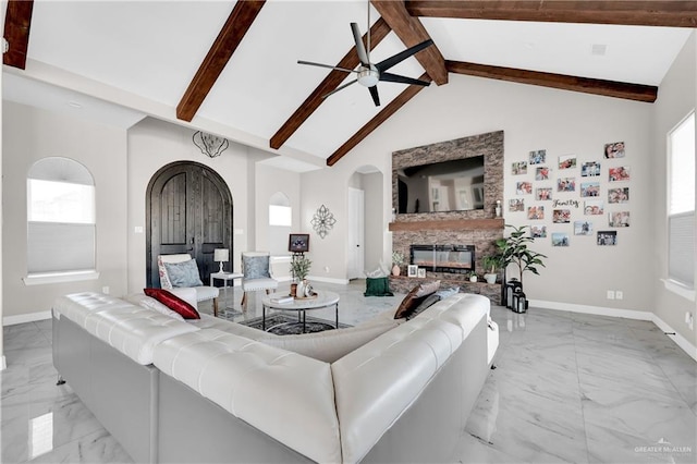 living room featuring beam ceiling, a fireplace, high vaulted ceiling, and ceiling fan