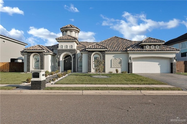 mediterranean / spanish-style home with a garage and a front lawn