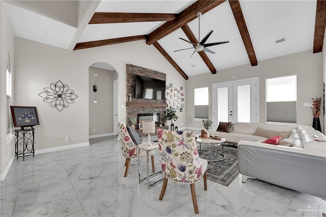 living room featuring ceiling fan, vaulted ceiling with beams, a fireplace, and french doors