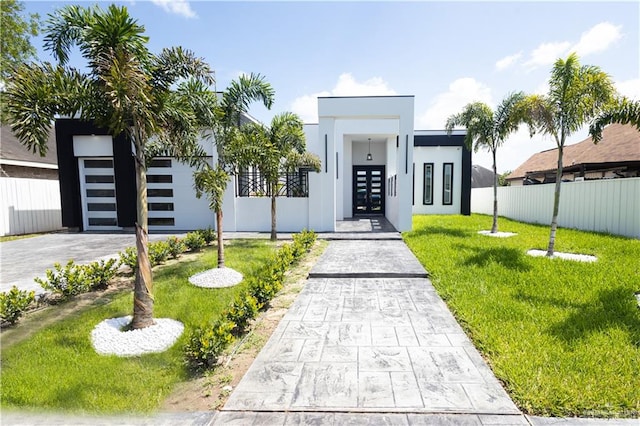 modern home with a front lawn and a garage