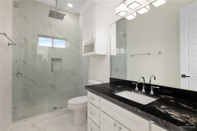 bathroom with toilet, vanity, and walk in shower