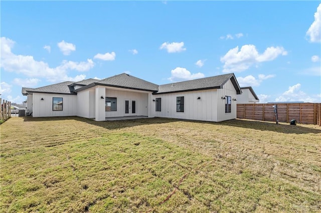 rear view of house featuring a yard