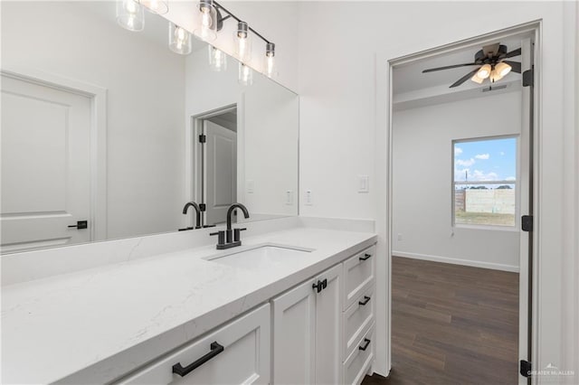 bathroom with hardwood / wood-style floors, ceiling fan, and vanity