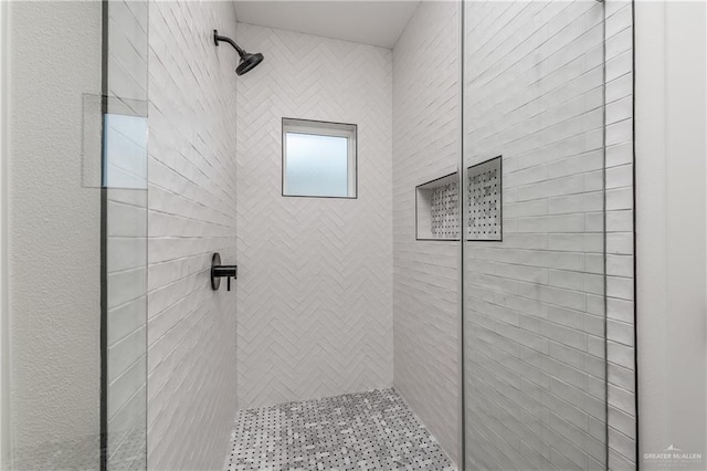 bathroom with a tile shower