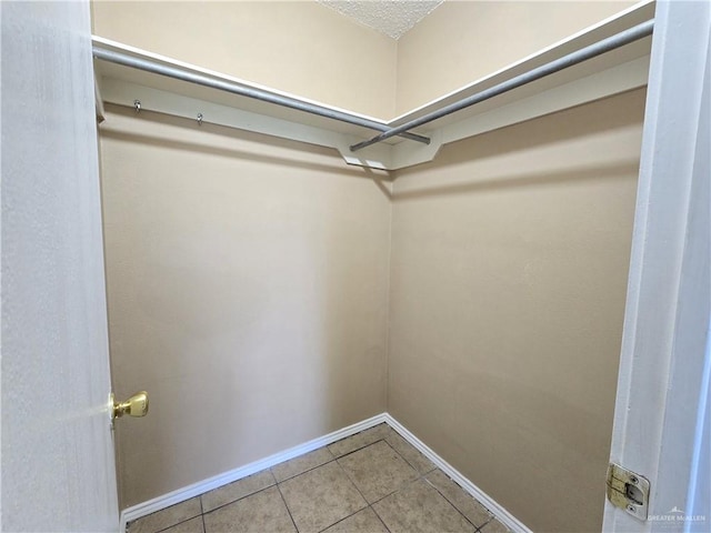 spacious closet featuring tile patterned flooring