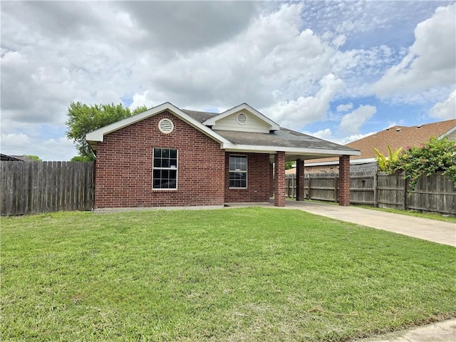 view of front of home with a front yard and a carport