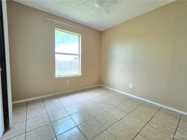 tiled spare room featuring ceiling fan and a textured ceiling