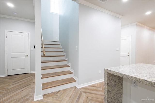 stairway with parquet flooring and crown molding