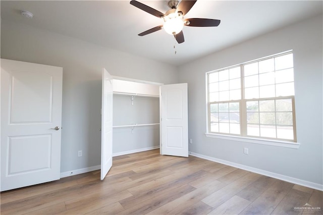 unfurnished bedroom with ceiling fan, light hardwood / wood-style floors, and a closet