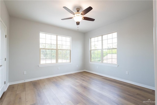 spare room with light wood-type flooring and ceiling fan