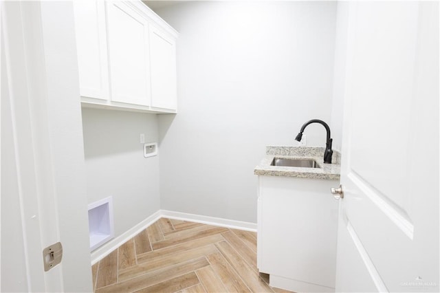 laundry room with cabinets, sink, light parquet flooring, and washer hookup