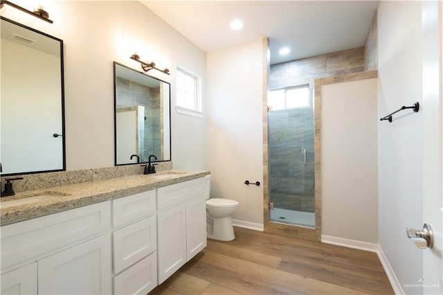 bathroom with walk in shower, wood-type flooring, toilet, and plenty of natural light