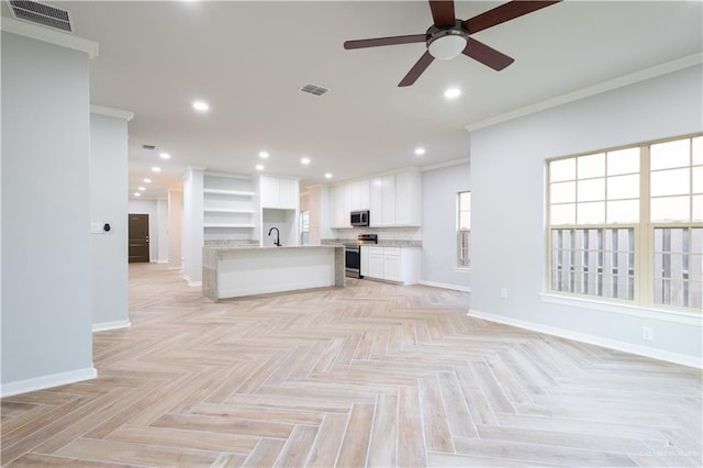 unfurnished living room featuring light parquet floors, ceiling fan, ornamental molding, and sink