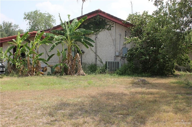 view of side of property with central AC