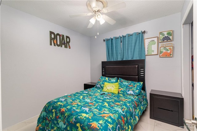 bedroom featuring ceiling fan and a textured ceiling