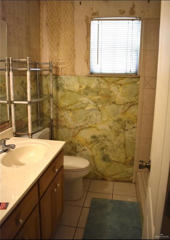 712 N Padre Ave, Weslaco, TX 78596 - bathroom with vanity, toilet, and tile patterned flooring