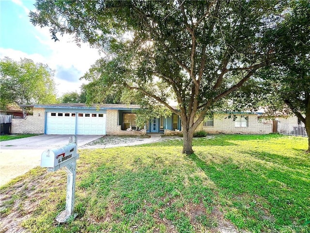 712 N Padre Ave, Weslaco, TX 78596 - single story home featuring a garage, driveway, and brick siding