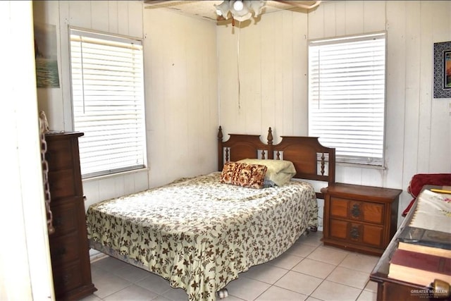 712 N Padre Ave, Weslaco, TX 78596 - bedroom featuring light tile patterned flooring and wooden walls