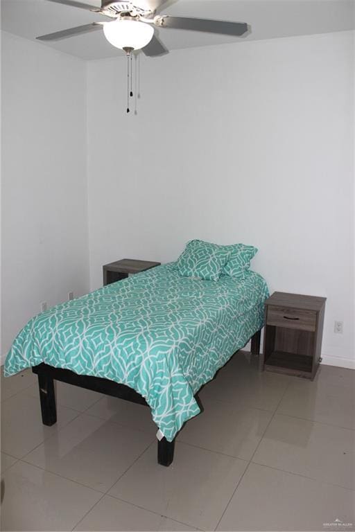 bedroom featuring baseboards, tile patterned floors, and ceiling fan