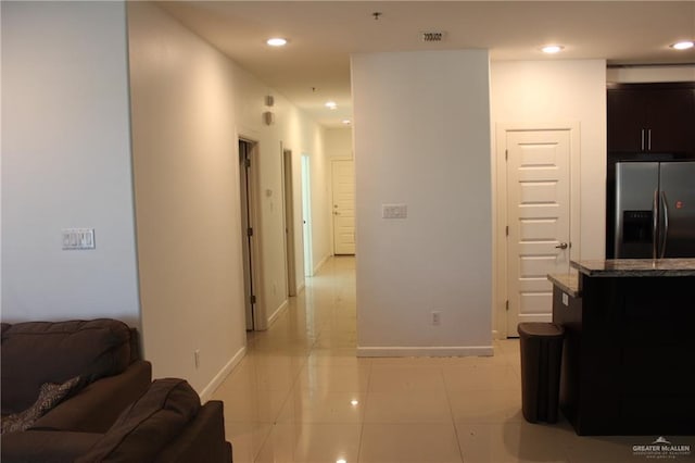 living room featuring recessed lighting, baseboards, and light tile patterned floors