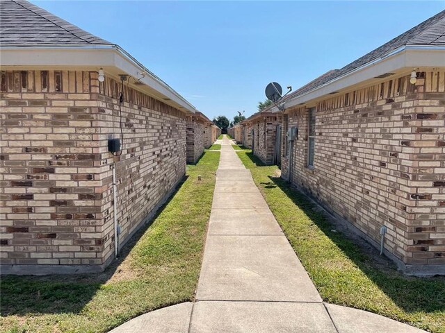 2015 W Western St, Edinburg, TX 78539 - view of side of property with brick siding and a yard