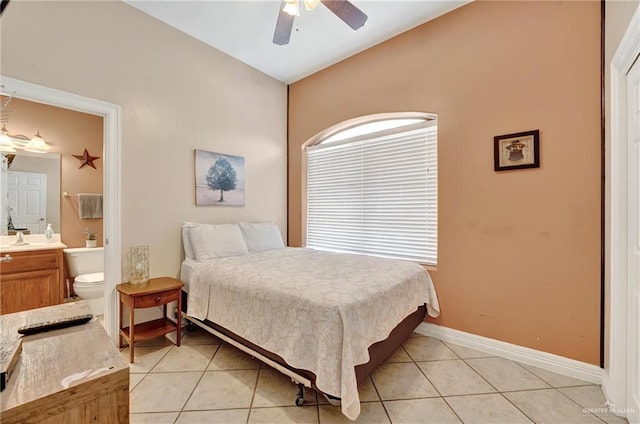 103 Gardenia St Unit 3, South Padre Island, TX 78597 - bedroom featuring lofted ceiling, light tile patterned flooring, baseboards, ensuite bath, and a ceiling fan